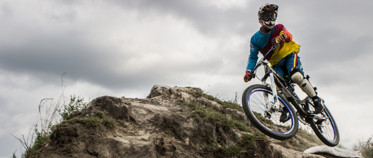 A downhill rider grabs some air