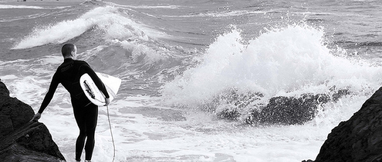 A surfer weighs up the swell in Woolacombe