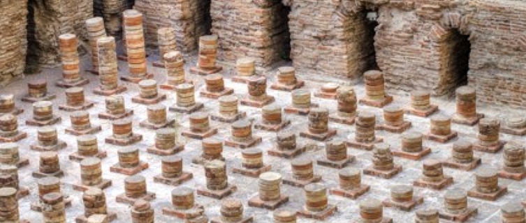 Archaeological ruins of brick vaults supporting the floor of the ancient Roman baths.