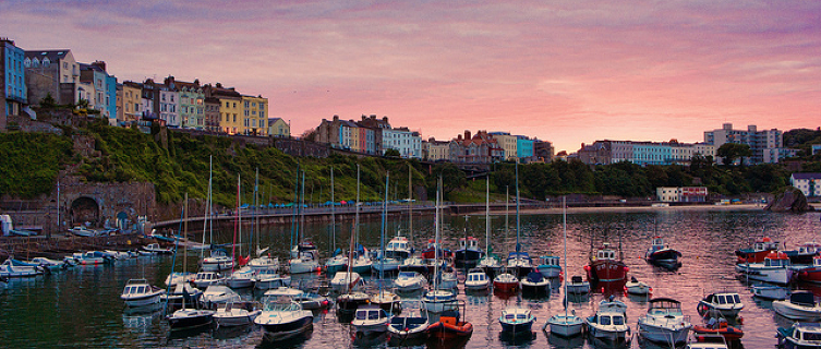 Pastel-hued buildings overlook Tenby's shimmering harbour